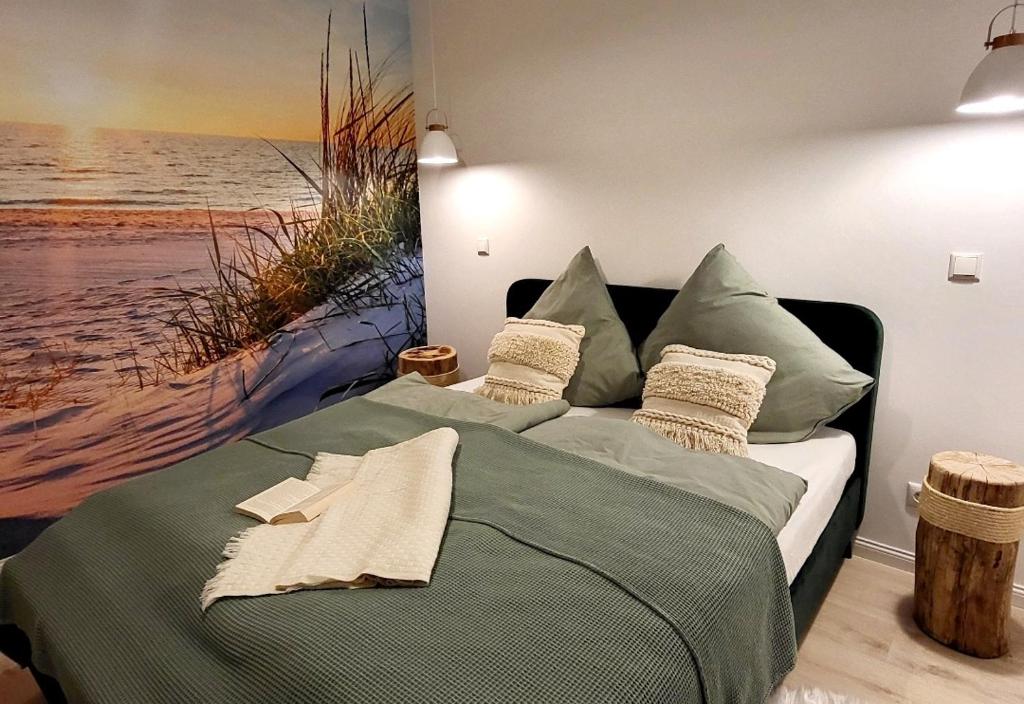 a bedroom with a bed with a painting of a beach at Friesenperle in Tönning