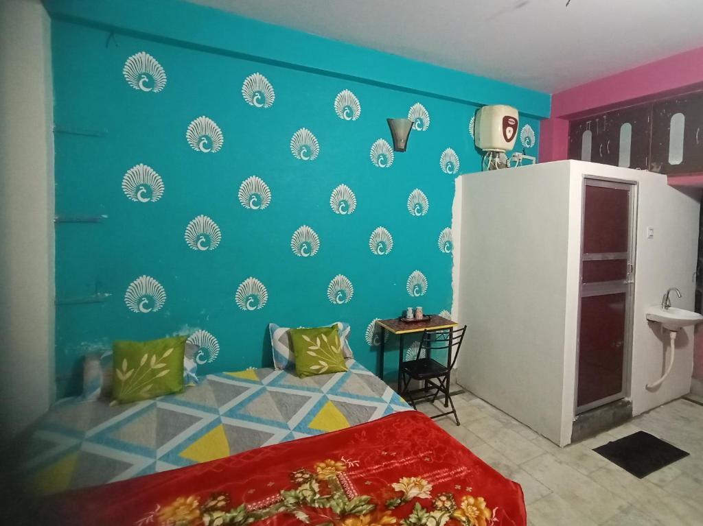 a bedroom with a bed and a blue wall at Welcome paying guest house in Varanasi