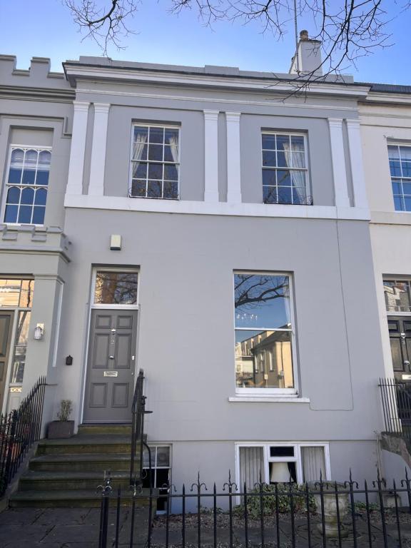 an image of a white house at No2 Clarence grade II Regency townhouse short walk to racecourse and town centre in Cheltenham