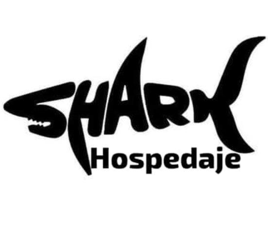 a shark logo with the words shark hospitable at Shark in Paso de los Libres