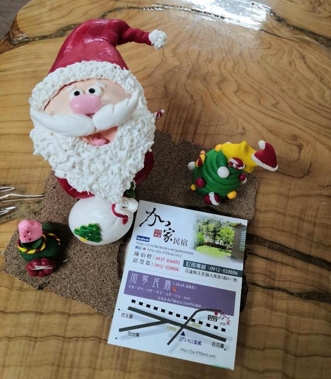 a santa claus figurine on a table next to a ticket at Jia Jia Homestay in Yuli