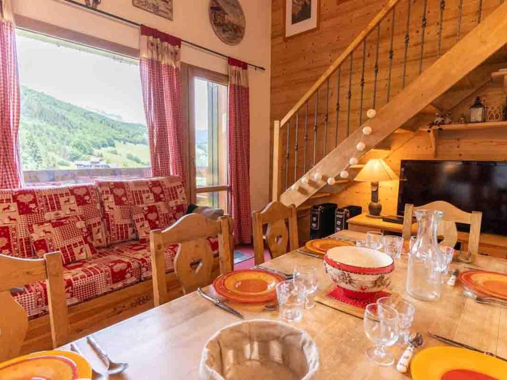 a dining room with a table and a couch at Appartement Valmorel, 4 pièces, 8 personnes - FR-1-291-784 in Valmorel