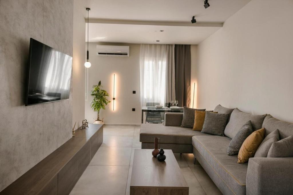 a living room with a couch and a tv at Argostoli Cityscape Apartment in Argostoli
