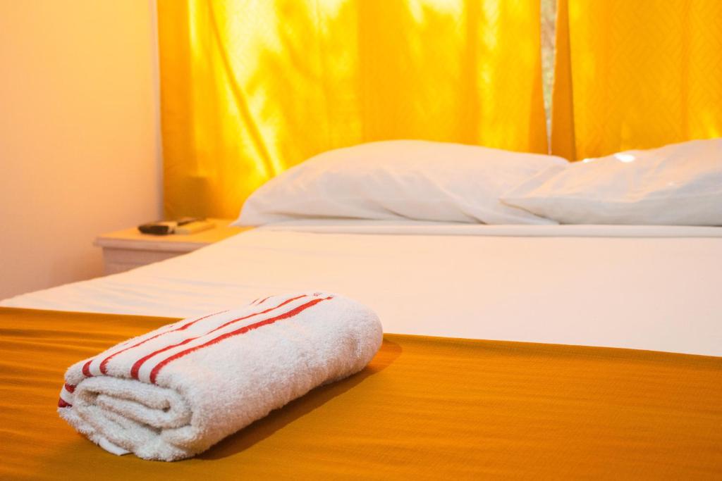 a towel laying on a bed on a table at Casa hotel las gaviotas II in Santa Marta