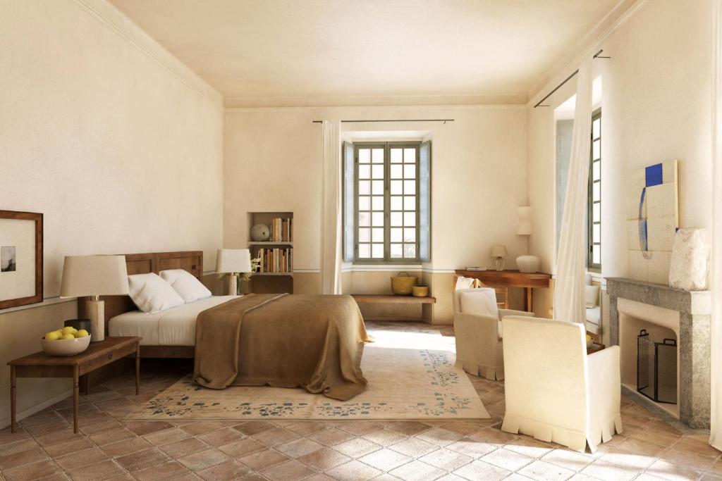 a bedroom with a bed and a fireplace at Hôtel du Couvent, a Luxury Collection Hotel, Nice in Nice