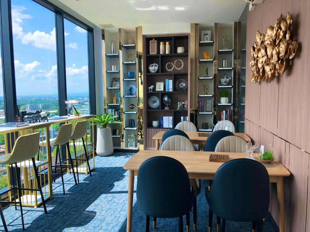 a dining room with a table and chairs at Astra Sky River Chiang Mai in Chiang Mai