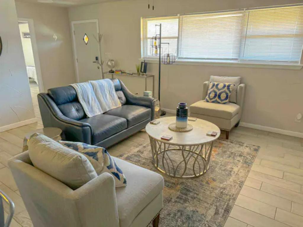 a living room with couches and a coffee table at Cozy, Fam Friendly Home Min from Stkyards in Fort Worth