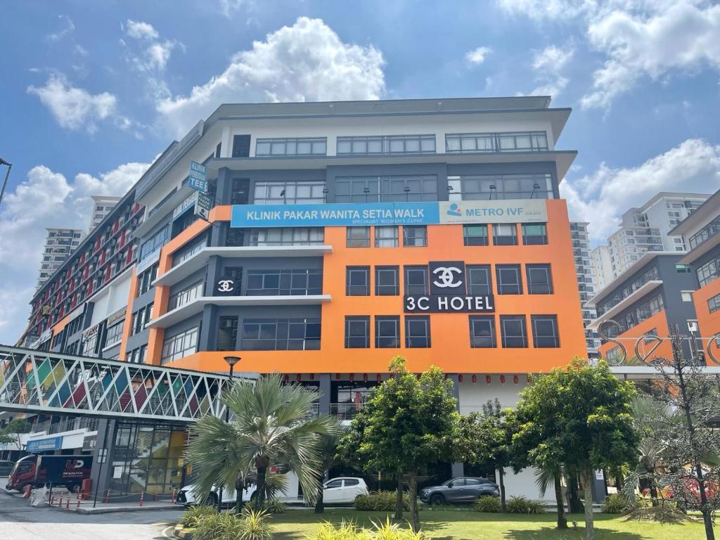 a large orange building with a sign on it at 3C HOTEL Setia Walk Puchong in Puchong