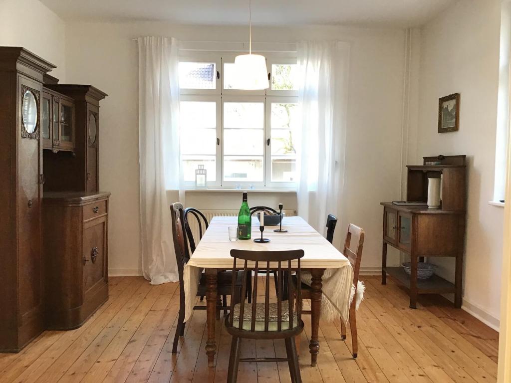 a dining room with a table with a bottle on it at Haus vor dem Schöneberger Tor in Hofgeismar