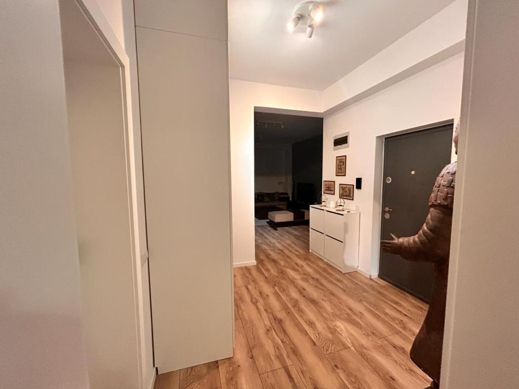 a hallway with a person standing in a room at Apartament Anca in Sibiu