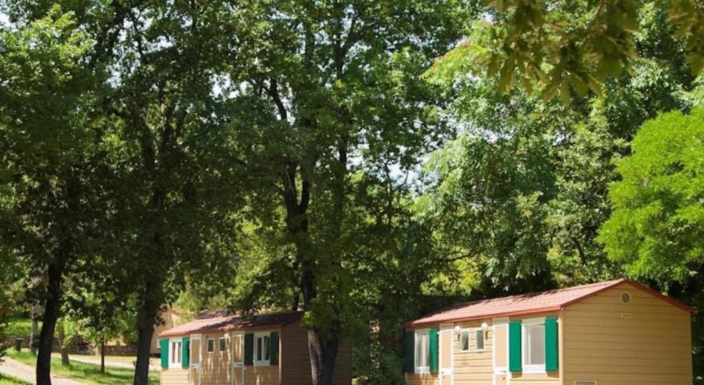 a couple of campsites next to some trees at hu Firenze Certosa camping in town in Impruneta