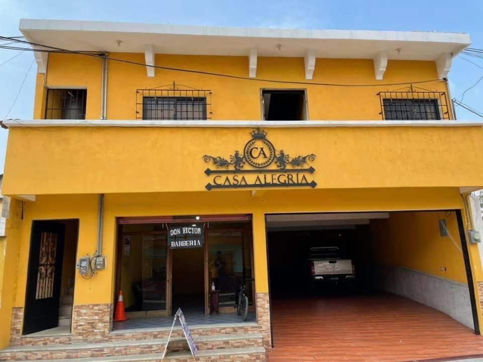 a yellow building with a sign that readsason african at Casa Alegria in Cobán