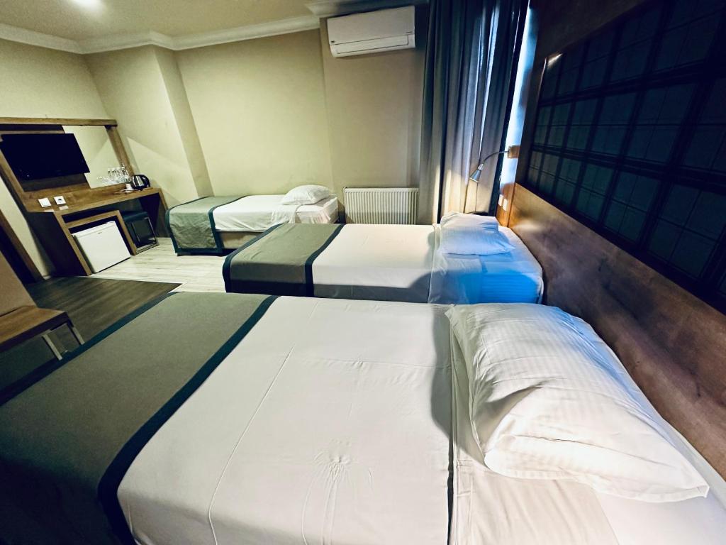 Postel nebo postele na pokoji v ubytování Laodikya Hotel