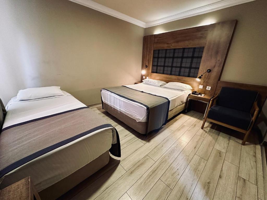 Postel nebo postele na pokoji v ubytování Laodikya Hotel