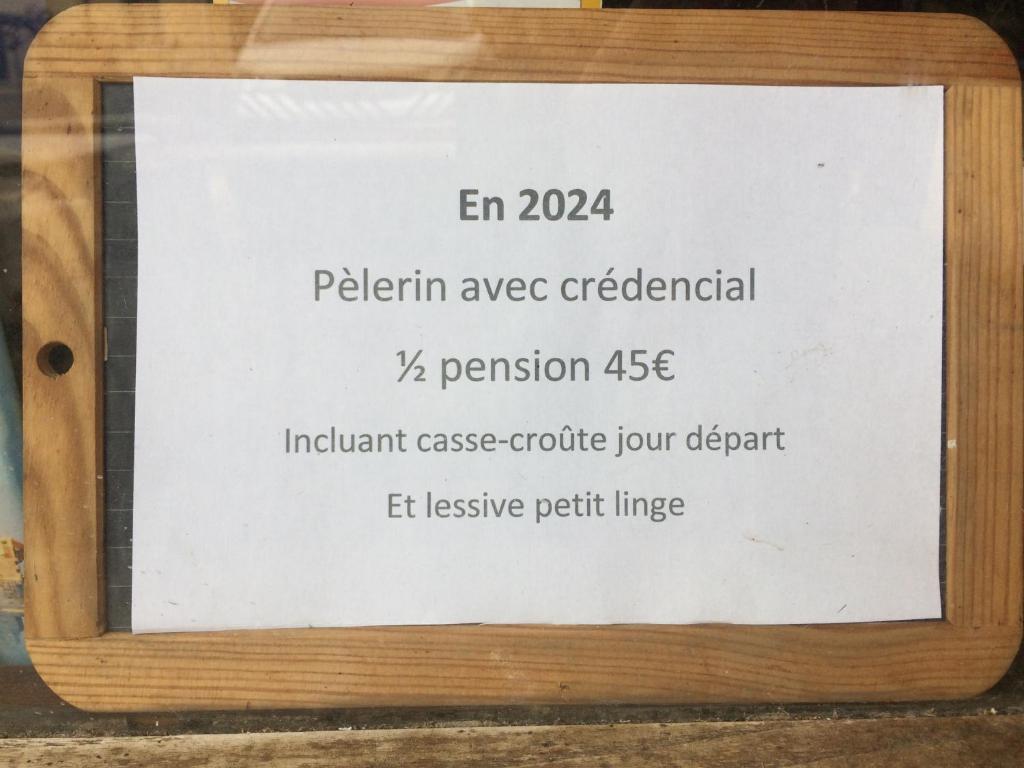 a sign in a wooden frame on a table with a sign for retention at AUBERGE LA ROMAINE in Maizières