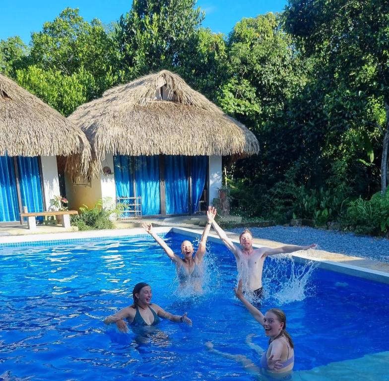 a group of people in the water in a swimming pool at NoMadders Ha Giang in Ha Giang