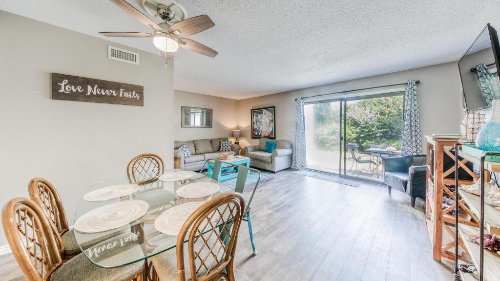 a dining room and living room with a table and chairs at Southbay 34 Beach Access 3 Bedroom Townhome in Destin