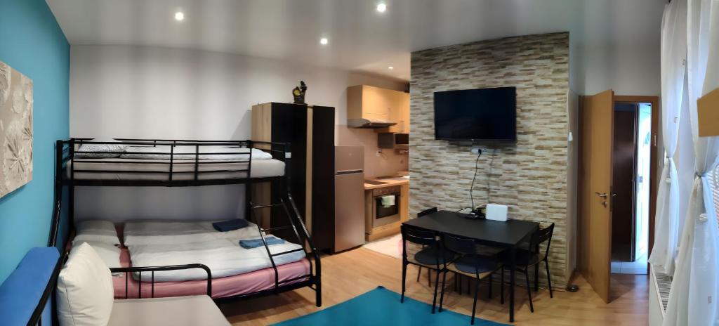 a room with two bunk beds and a table at Blue apartment in City Center, Best location in Bratislava