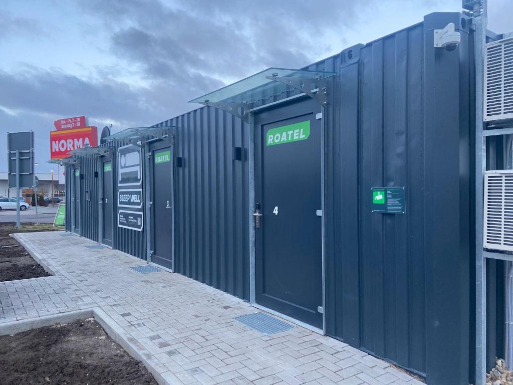 a row of portable toilets in a parking lot at Roatel Magdeburg A2 my-roatel-com in Magdeburg