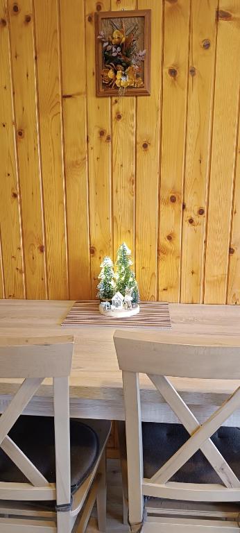 a wooden table with a plant on top of it at Apartmány Grobarčík in Zuberec