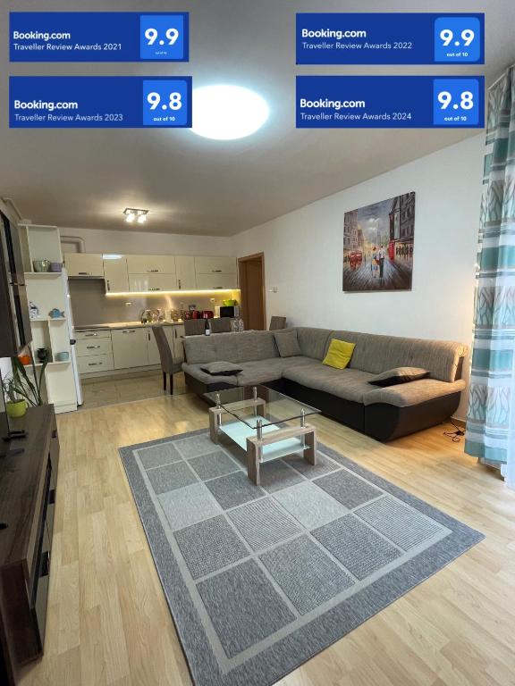 a living room with a couch and a table at Casa Blanca in Nyíregyháza