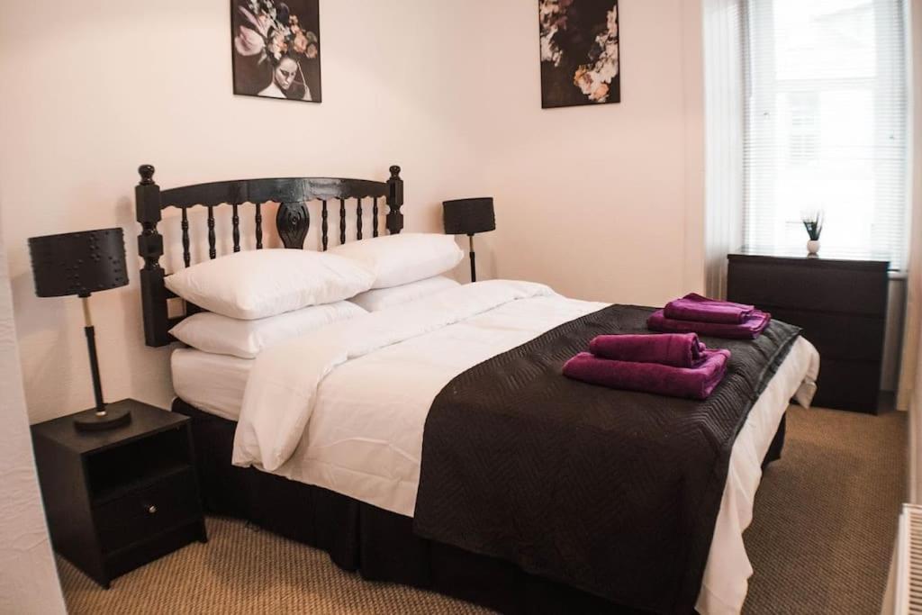 a bedroom with a large bed with two pillows on it at The Scot in Perth