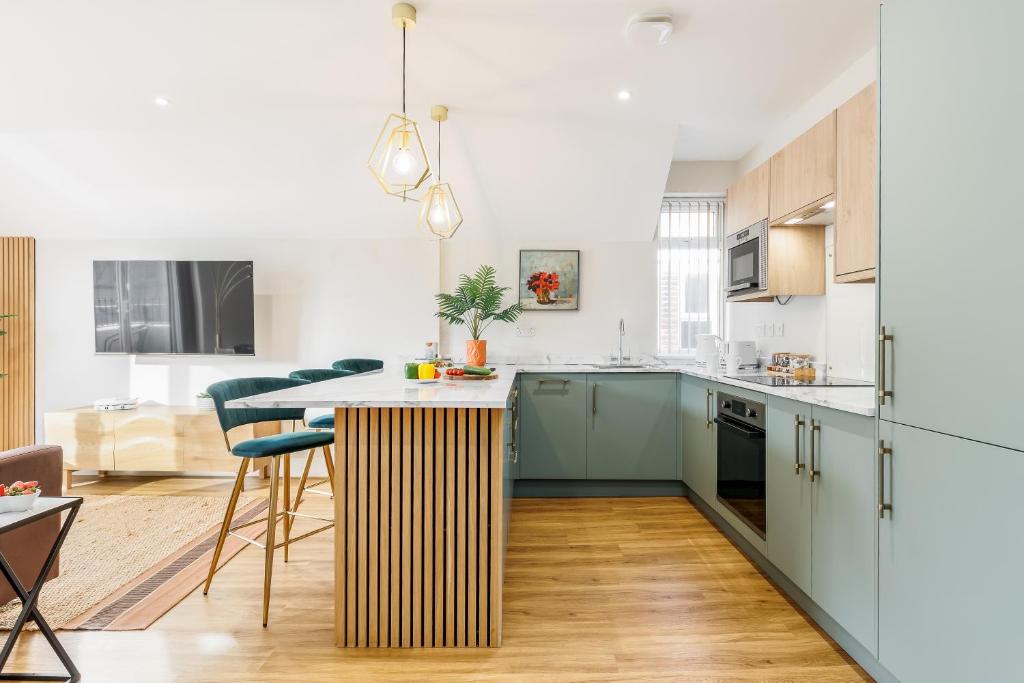 a kitchen with a island in the middle of a room at Sea Breeze - Pebbles in Bournemouth