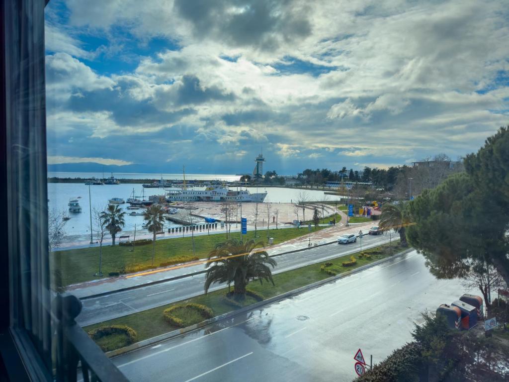 a view from a window of a road and a harbor at Mihman Hotel in Tuzla