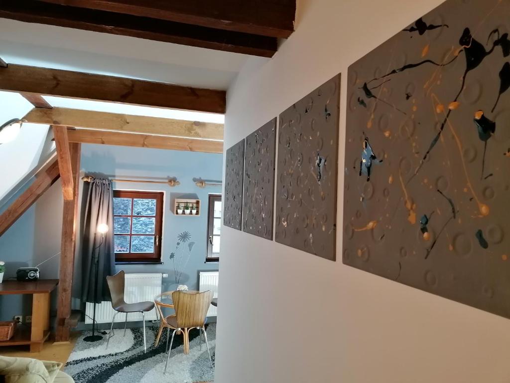 a living room with a wall mural of butterflies at Guest House Olšakovský in Český Krumlov