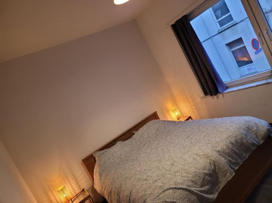 1 dormitorio con cama y ventana en Appartement in een bruisende omgeving!, en Amberes