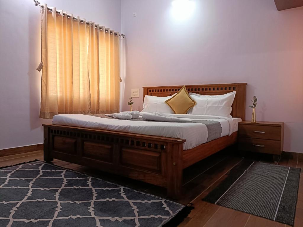 a bedroom with a bed with white sheets and a window at CasaBonito 3BHK Villa in Mysore