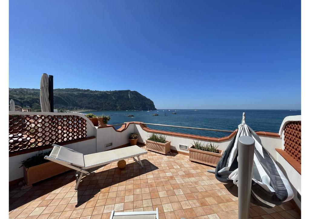 d'un balcon avec un banc et une vue sur l'océan. dans l'établissement The Lodge by the sea, à Ischia