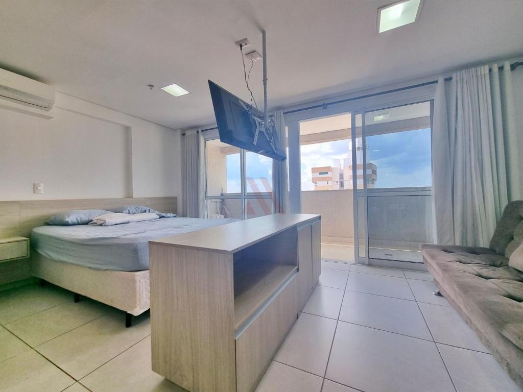 a room with a bed and a desk with a bed sidx sidx sidx at Flat Brookfield Towers in Goiânia