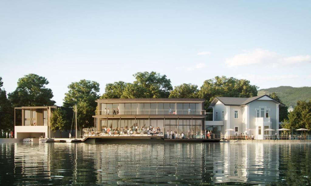 a rendering of a house on a dock on the water at Apollo AchtQuartier Das Hotel am Mondsee in Mondsee