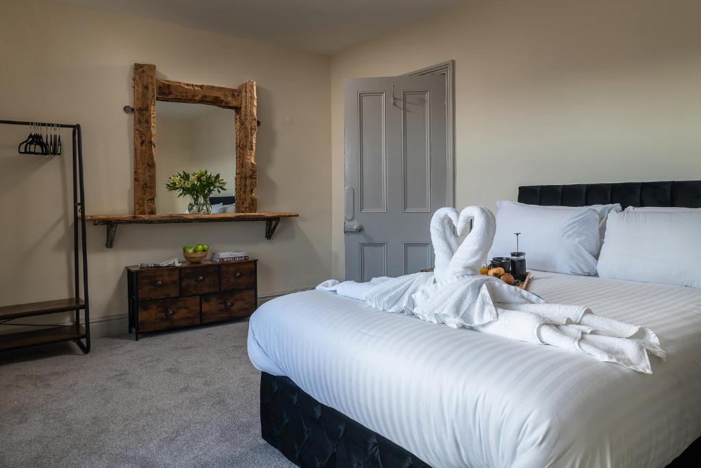 a bedroom with a bed with a swan decoration on it at Orme Lodge in Llandudno