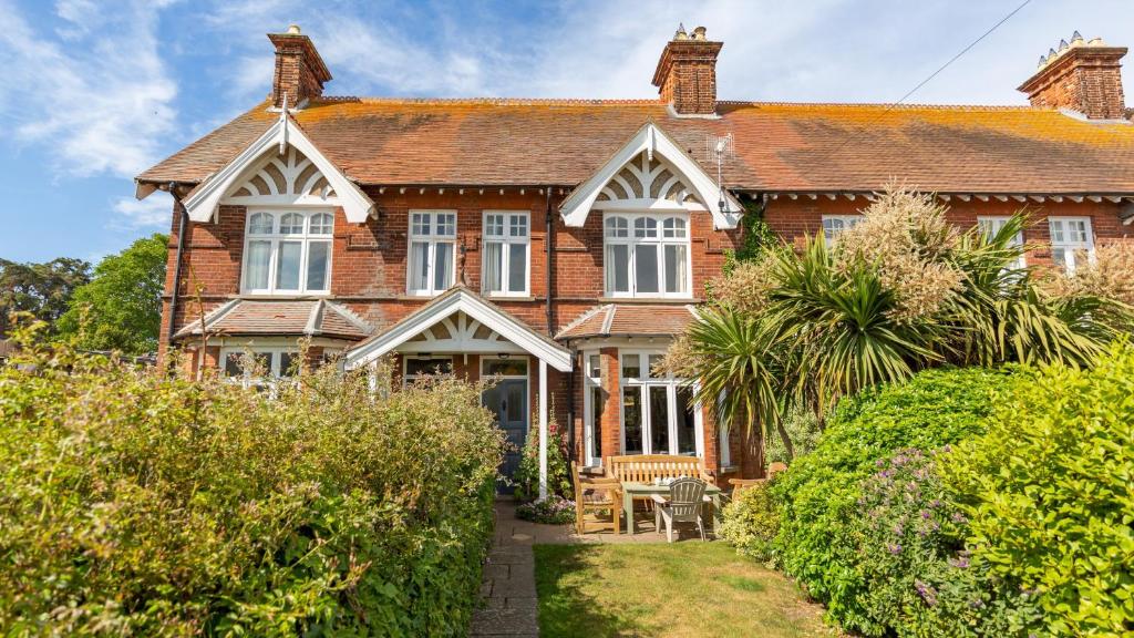 an old brick house with a garden in front of it at Thalassa in Walberswick