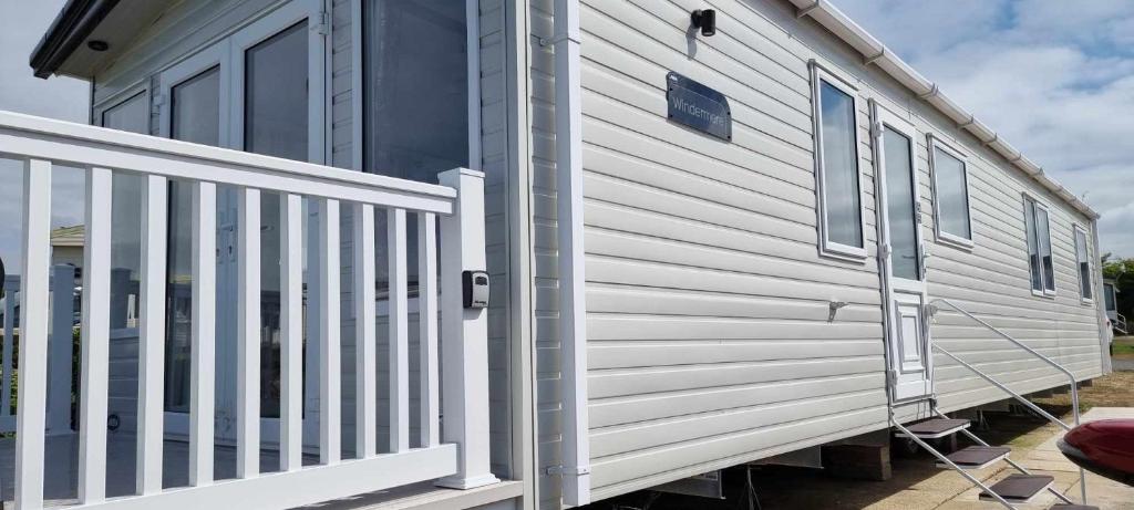 a mobile home with a white railing and stairs at Littlesea-wv55 Weymouth in Wyke Regis