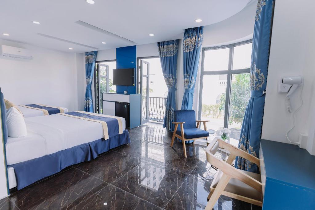 a hotel room with a bed and a chair at ARINA HOTEL in Tây Ninh