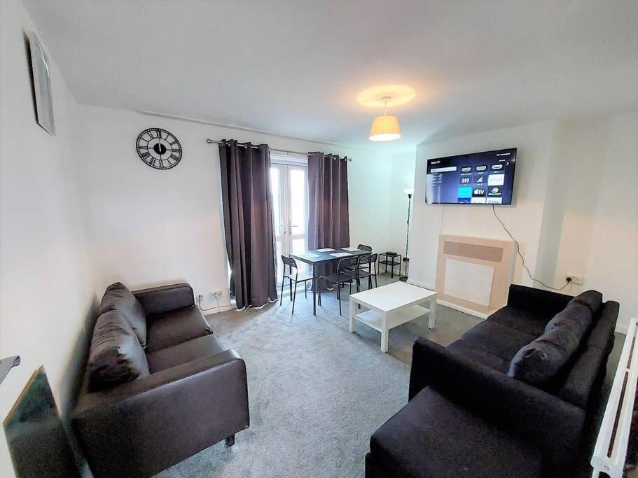 a living room with two couches and a table at 3 bedroom Flat in Hoxton London in London