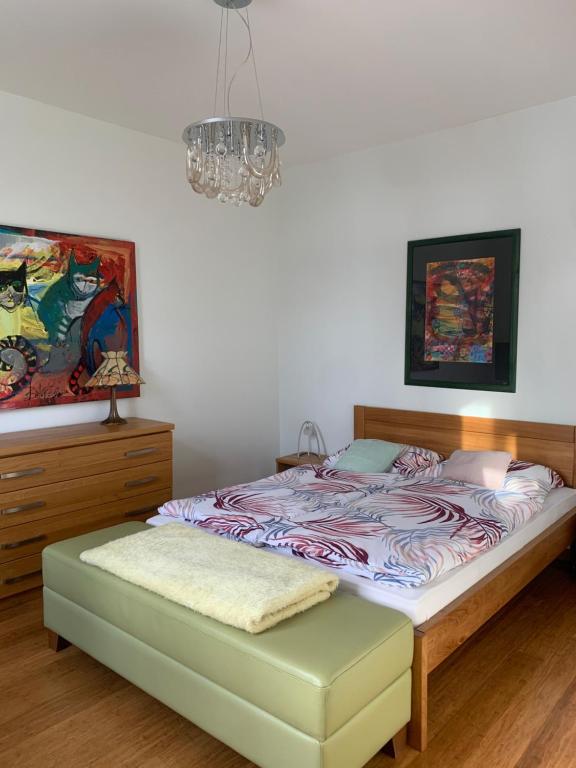 a bedroom with a bed and a chandelier at Apartmán Vierka in Vysoké Tatry