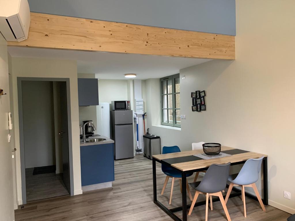 a kitchen and dining room with a table and chairs at Appartement Hanami - Maulévrier Cholet Puy du Fou in Maulévrier