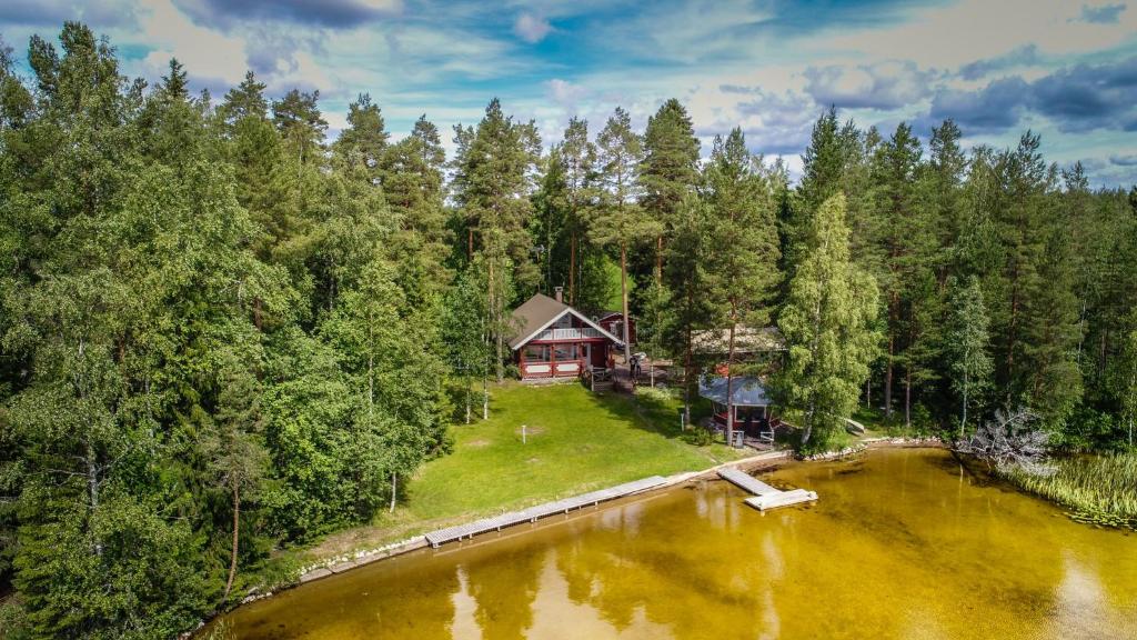 an aerial view of a house next to a lake at Villa Kuusiranta in Ähtäri
