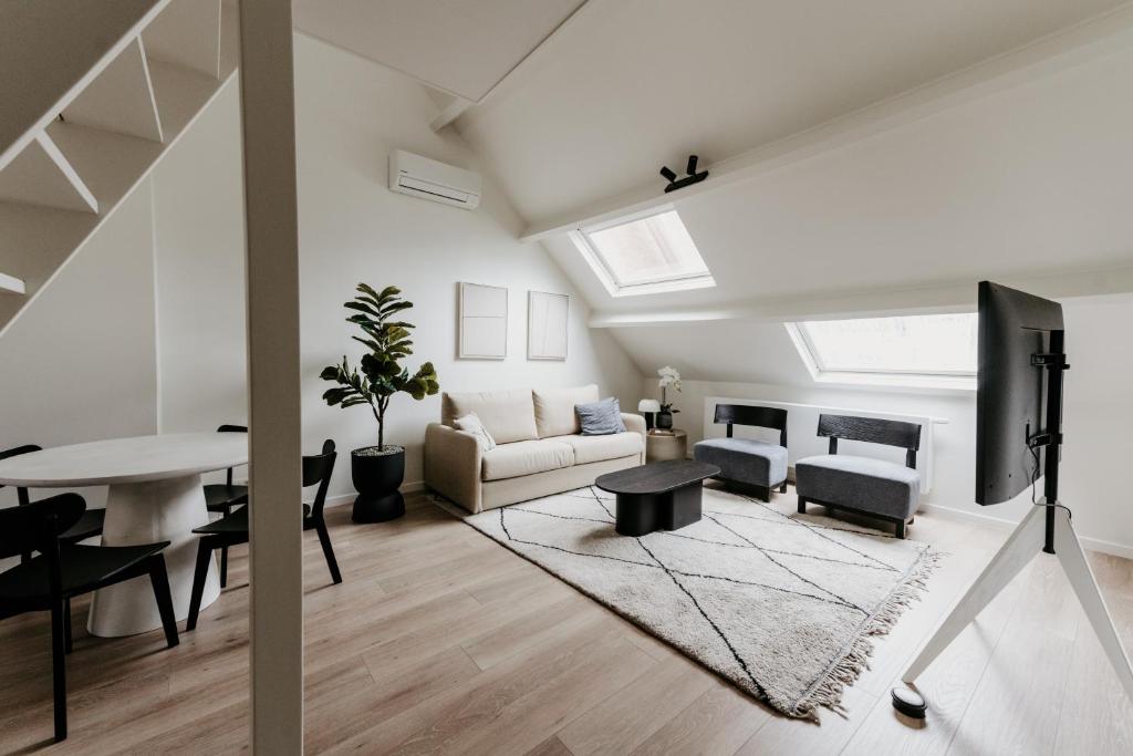 a living room with a couch and a table at Cathedral view from the bathtub in Antwerp