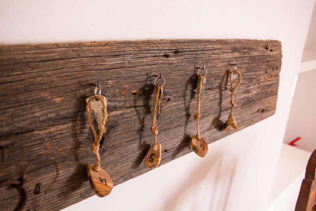 a group of wooden hooks hanging on a wall at Monte Oliva - Turismo Rural in Cerro da Zorra