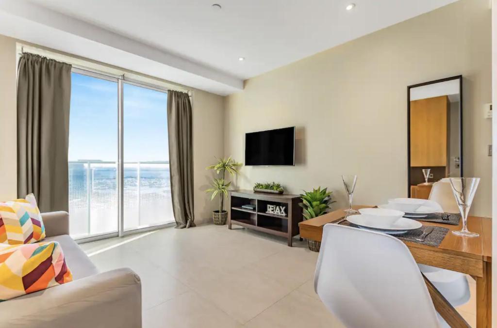 a living room with a view of the ocean at West One Studio Apartments in Gibraltar