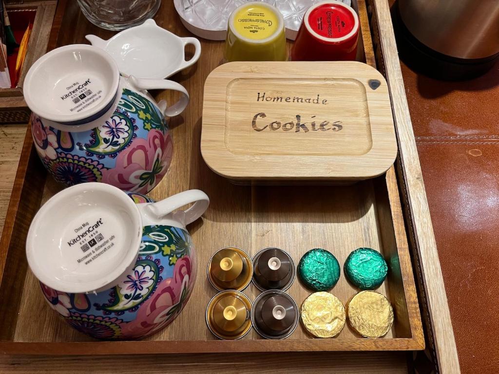 a wooden tray with a tea set and chocolates at Ceol na Mara Guest House in Tarbert