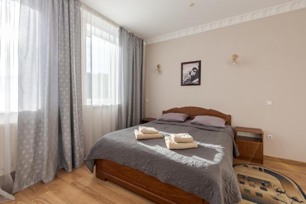 a bedroom with a bed with two towels on it at Вілла ЮРАН Східниця in Skhidnitsa