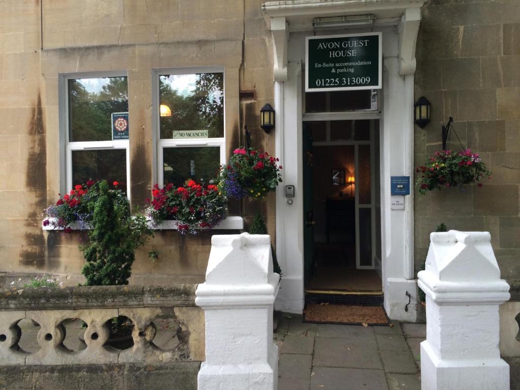 a building with flowers on the front of it at Avon Guesthouse in Bath