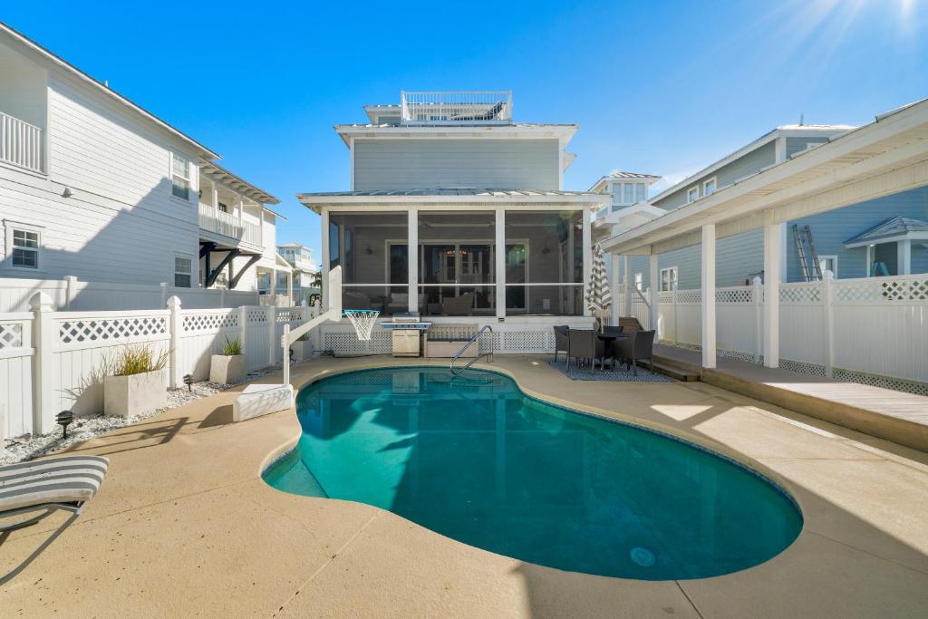 a swimming pool in the backyard of a house at Destin Beach House - Gulf Moon by Panhandle Getaways in Destin