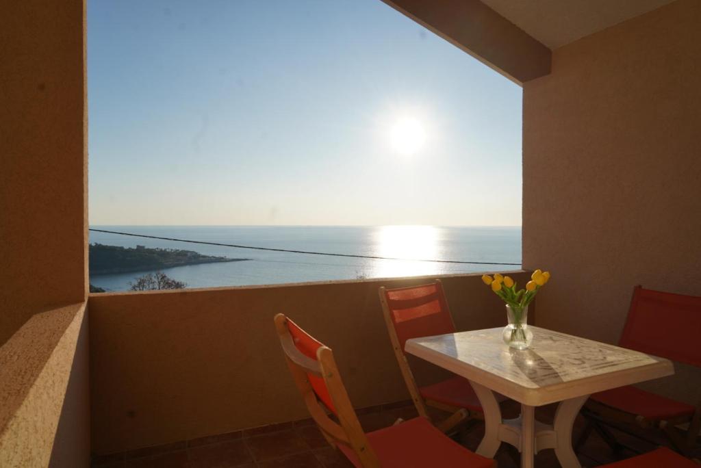 a table and chairs with a view of the ocean at Apartments Safija in Dobra Voda
